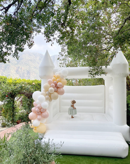 USA-made white bounce house set up at an outdoor celebration