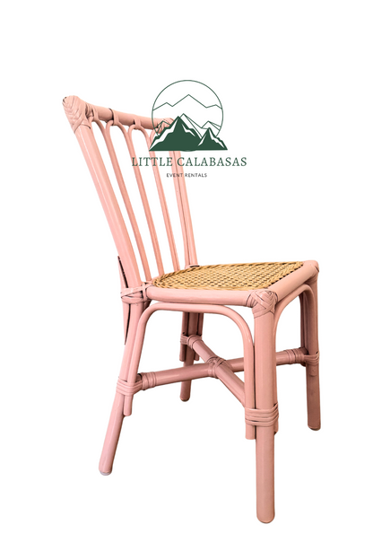 A pink rattan dining chair with a woven cane seat, shown from a three-quarter angle against a plain white background. A watermark logo for 'Little Calabas Furniture' is visible near the top center.