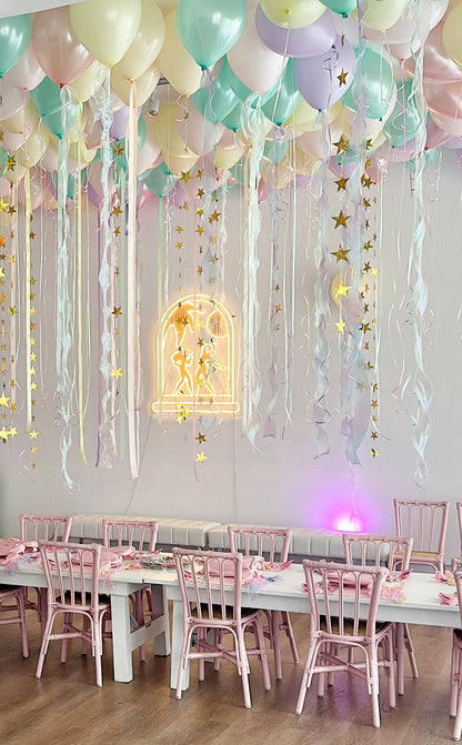 Light pink rattan kids chair at an event setup