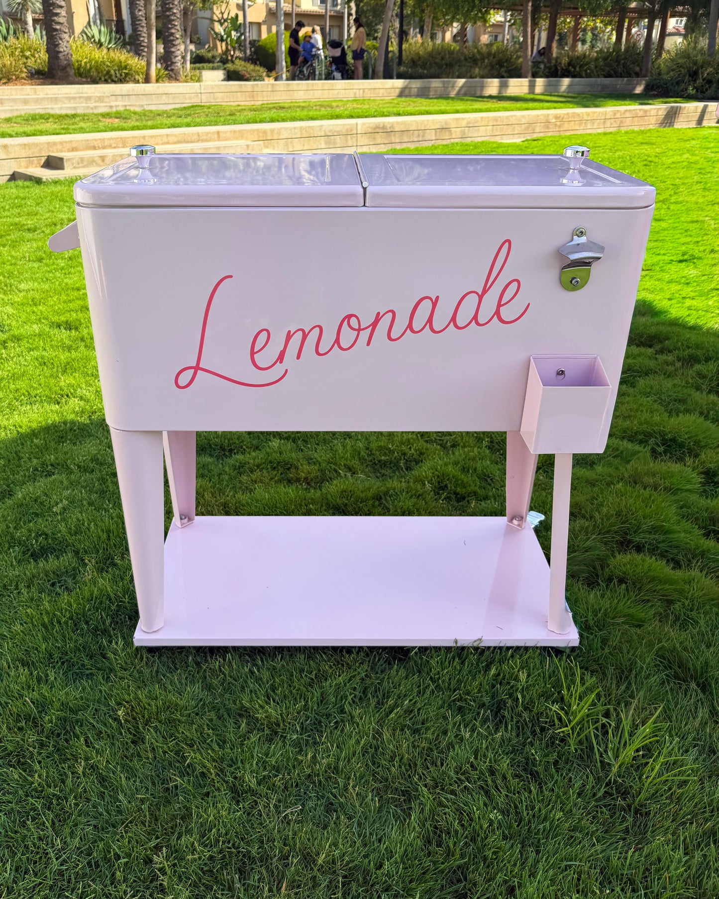 Pink ice cooler styled as a lemonade stand