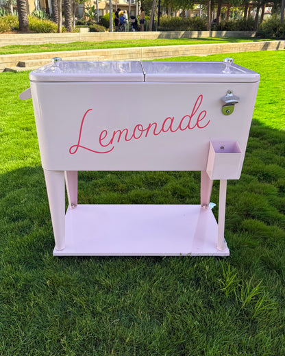 Pink ice cooler styled as a lemonade stand